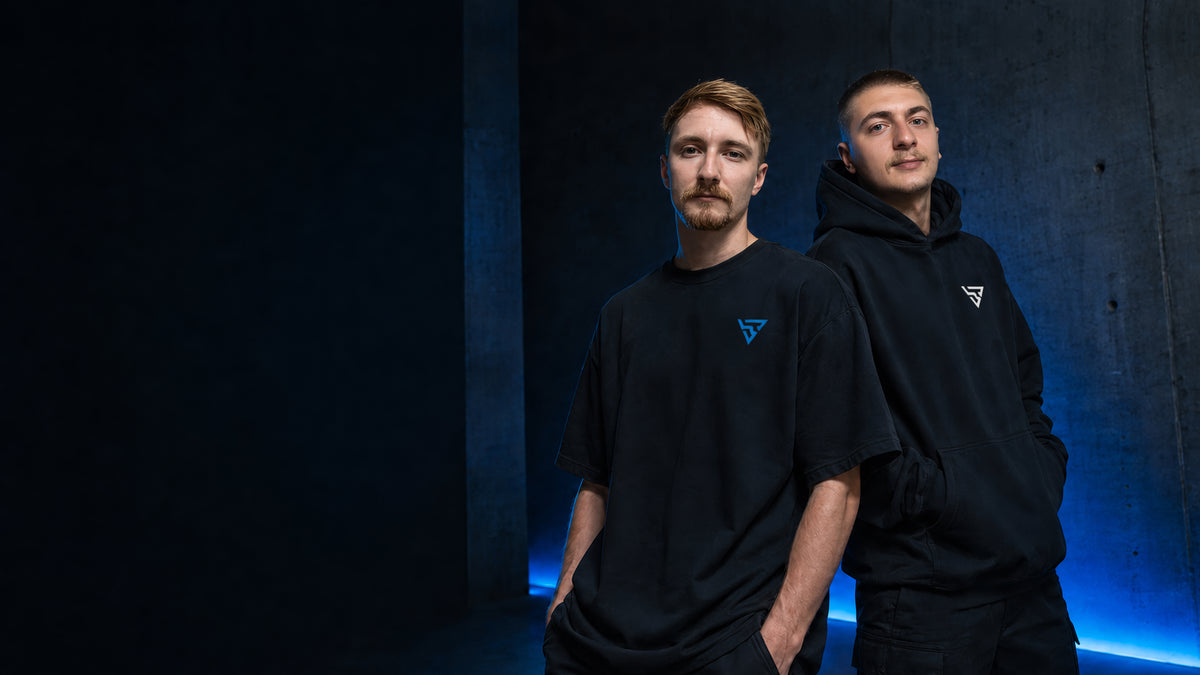 Two people wearing understated black BV apparel